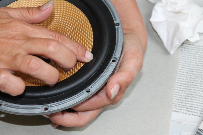 B&W ZZ11436 repair: Now glue the inner lip of the rubber surround onto the cone. Support the cone with your other hand.